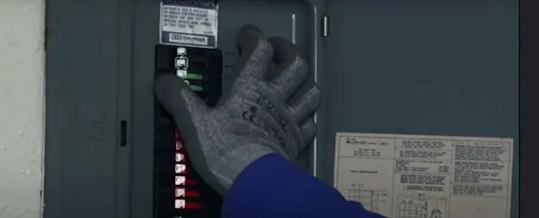 Image of homeowner shutting off the circuit breaker for the stove